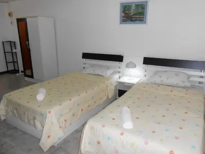 two beds sitting next to each other in a bedroom at MT-Room in Bangkok