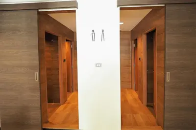 a row of glass doors in a hallway at T Hostel @ Victory Monument in Bangkok