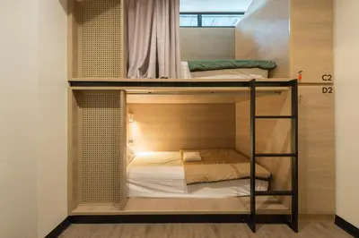 two bunk beds in a small room at T Hostel @ Victory Monument in Bangkok