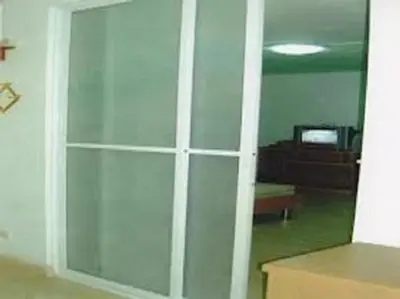 a glass door in a room with a living room at DMK Don Mueang Airport Guest House in Bangkok