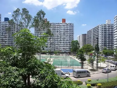 a tennis court in a parking lot in a city at DMK Don Mueang Airport Guest House in Bangkok