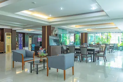 a dining room with a table and chairs at The Wing Design Hotel in Bangkok