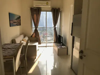 a living room with a view of a balcony at river front in Nonthaburi