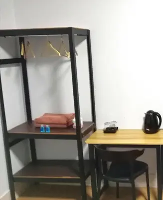 a room with a desk and a book shelf at U&D guest house in Bangkok