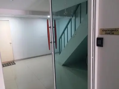 a glass door with a staircase in a room at DD Garden Apartment 2 in Bangkok