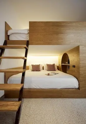 a bedroom with two bunk beds with white sheets at B House 49 Bangkok in Bangkok