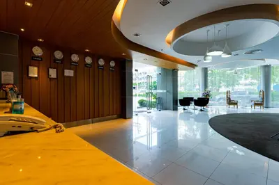 a large room with clocks on the walls and a lobby at Royal Delight Hotel in Bangkok