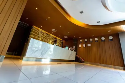 a lobby with a large screen in a building at Royal Delight Hotel in Bangkok