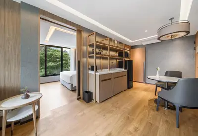 a room with a bed and a table and chairs at Homm Sukhumvit34 Bangkok in Bangkok