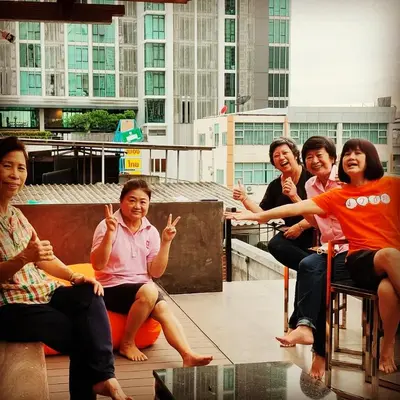 a group of women sitting on top of a building at Station8 Hostel in Bangkok