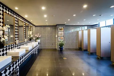 a bathroom with a row of sinks and mirrors at Lux Boutique Hotel in Nonthaburi