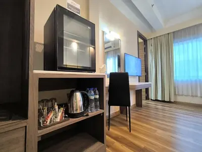 a room with a desk with a chair and a television at Citin Sukhumvit 11 Nana Bangkok by Compass Hospitality in Bangkok