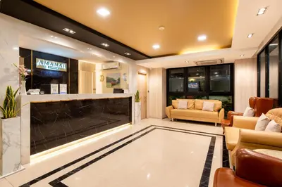 a living room with a fireplace and a tv at Amanah Bangkok Hotel in Bangkok
