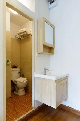 a bathroom with a sink and a toilet at Arawana Residence Phromphong in Bangkok