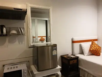 a small room with a television and a bed at Arawana Residence Phromphong in Bangkok