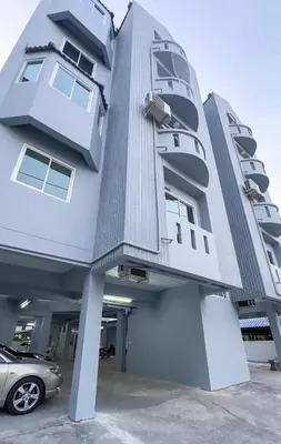 a building with a car parked in front of it at Baan Khun Pra Duplex Rm3 Bangkok in Bangkok