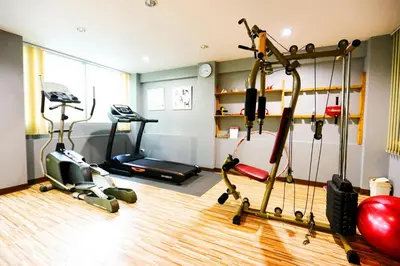 a gym with exercise equipment in a room at Bellevue Boutique Bangkok in Amphoe Phra Khanong