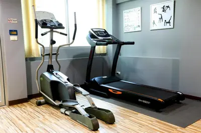 a gym with a treadmill and an exercise bike at Bellevue Boutique Bangkok in Amphoe Phra Khanong