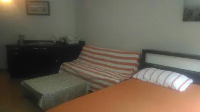 a bedroom with a bed and a bench and a dresser at Airport Transfer Bangkok apartment in Thung Si Kan