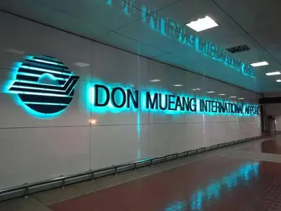 a sign on a wall in a building at Airport Transfer Bangkok apartment in Thung Si Kan