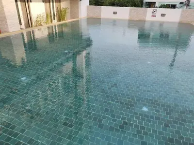 a swimming pool with blue tiles on top of it at LeeNova Place in Lat Krabang