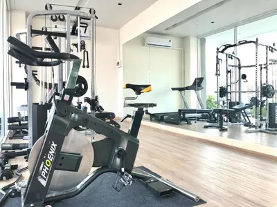 a gym with tread machines and a treadmill at LeeNova Place in Lat Krabang