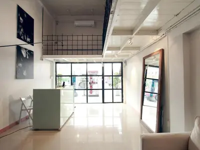 an empty room with a counter and some windows at Bangkok Hub Hostel in Bangkok