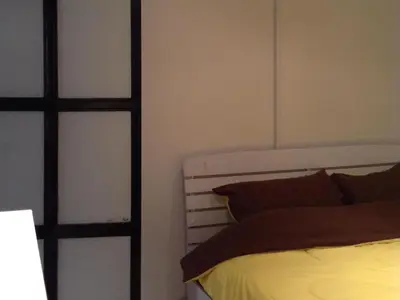 a bedroom with a bed and a glass door at Bangkok Hub Hostel in Bangkok