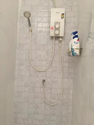 a shower with a shower head and a shower at Bangkok Hub Hostel in Bangkok