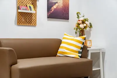 a living room with a couch and a table at My space69 in Ban Pak Khlong Khwang