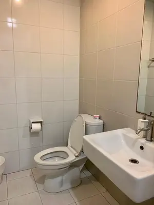 a bathroom with a toilet and a sink at LKN RESIDENCE in Pom Prap