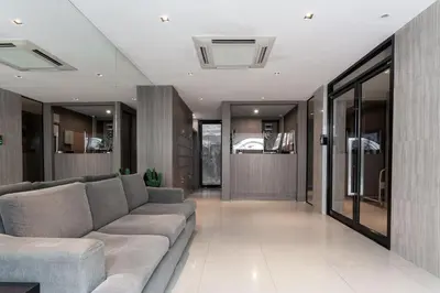 a living room with a couch and a hallway at LKN RESIDENCE in Pom Prap