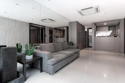 a living room with a couch and a table at LKN RESIDENCE in Pom Prap