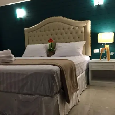 a bedroom with a large bed with a flower on it at I-Inn Hotel in Bangkok