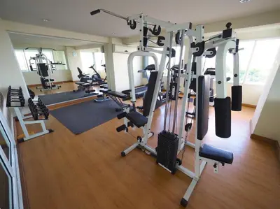a gym with several treadmills and exercise bikes at The View Residence in Bangkok