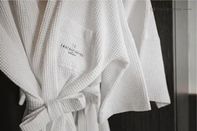 a white robe with a bow on it at Cascade Hotel Bangkok in Bangkok