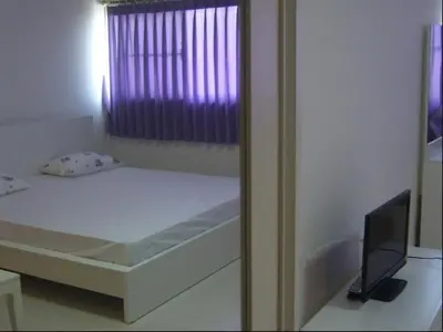 a small bed in a room with a window at Family Room Dmk Don mueang Airport 2 bedrooms in Ban Bang Phang