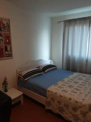 a small bedroom with a bed and a window at Chan Kim Don Mueang Guest House Triple room in Thung Si Kan