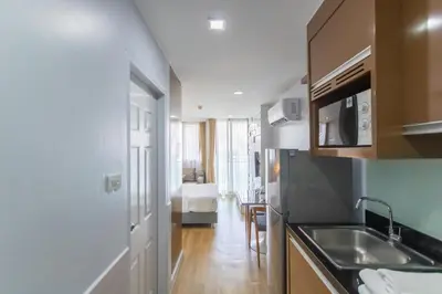 a kitchen with a sink and a counter top at United Residence Ekamai Bangkok in Bangkok