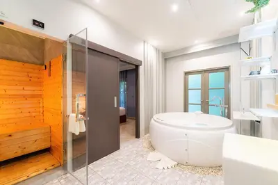 a bathroom with a large tub and a shower at W1Bangkoknoi Hotel in Nonthaburi
