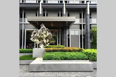 a building with a statue in front of it at The Base Park East - Bangkok Sukhumvit 77 in Bangkok