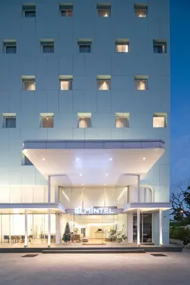 a large building with a lit up facade at Mintel Huamark in Bangkok