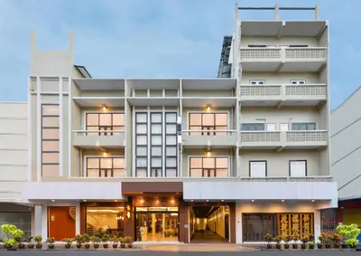 a large white building with a store front at Oldthaiheng Hotel in Bangkok