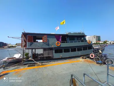 a ferry boat with a flag on top of it at Sabai Sabai Liveaboard Bangkok in Bangkok
