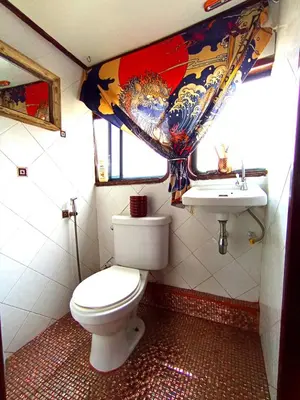 a bathroom with a toilet and a sink at Sabai Sabai Liveaboard Bangkok in Bangkok