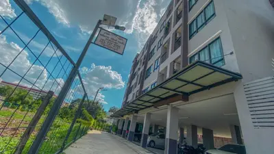 a building with a street sign in front of it at Plearnwan Deluxe Mansion in Bangkok