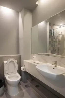 a bathroom with a white toilet and a sink at Haven 35 in Bangkok