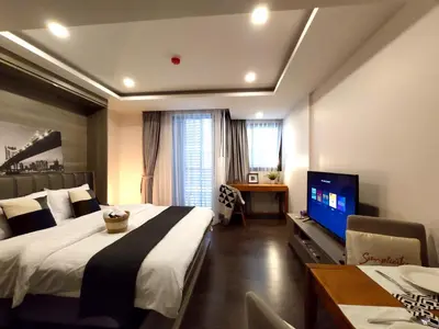 a bedroom with a large bed and a television at Circle Rein Sukhumvit 12 #1BR#Pool&Gym#Near Terminal 21#Max2 in Bangkok