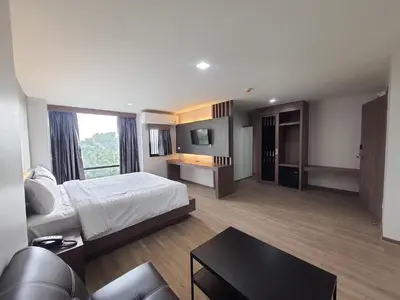a hotel room with a bed and a couch at โรงแรมดับเบิ้ลดี ปากเกร็ด Double D hotel in Pak Kret