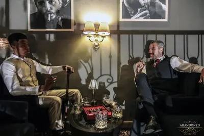 a group of men sitting in chairs in a room at The Coach Hotel Sukhumvit - Asok BTS Bangkok in Bangkok